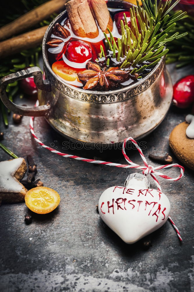 Mulled wine with dried fruits on winter decoration