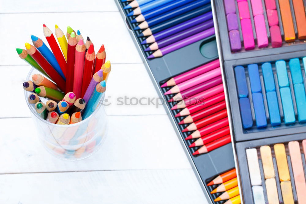 Similar – Crayons scattered on desktop filled with colorful drawings