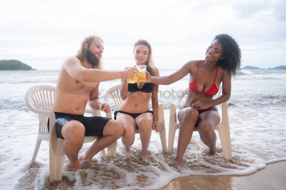 Similar – Young adult girls drinking beer at the beach and having fun