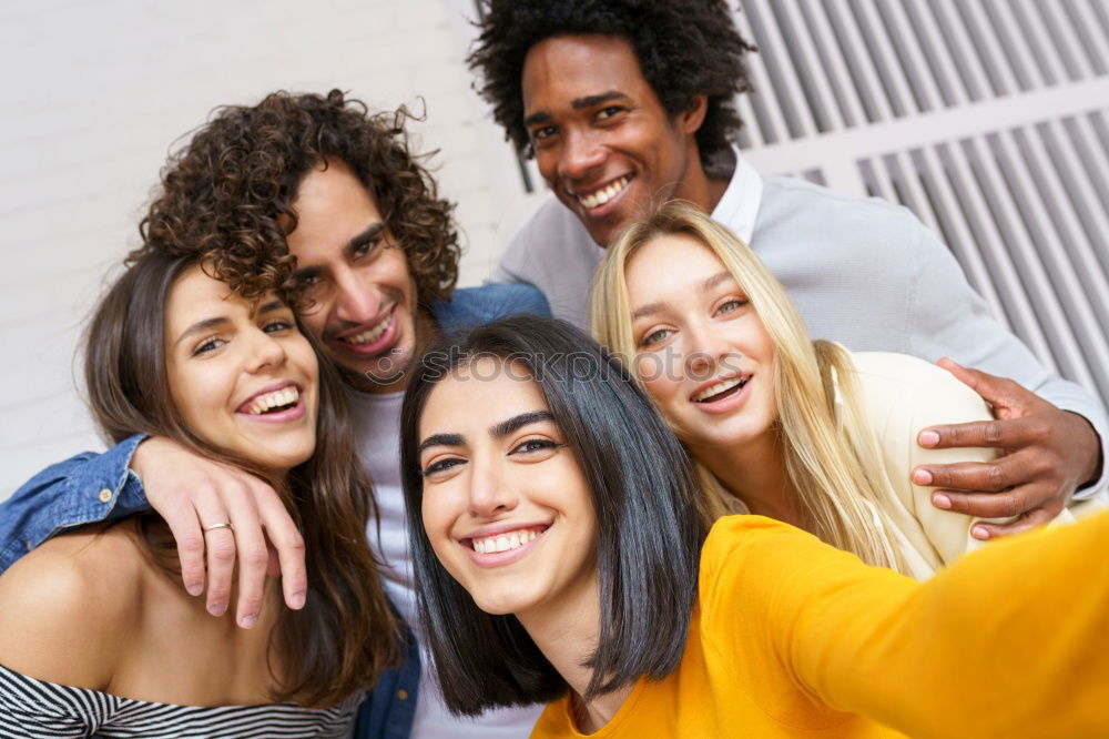 Similar – Multiracial group of friends taking selfie together