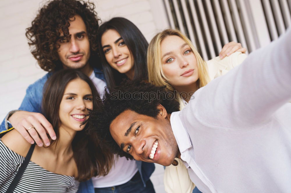 Similar – Multiracial group of friends taking selfie together