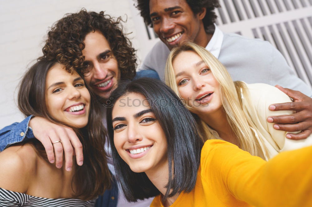 Multiracial group of friends taking selfie together