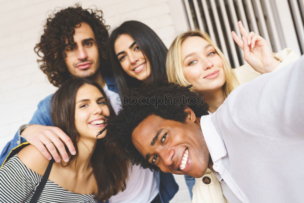 Similar – Multiracial group of friends taking selfie together