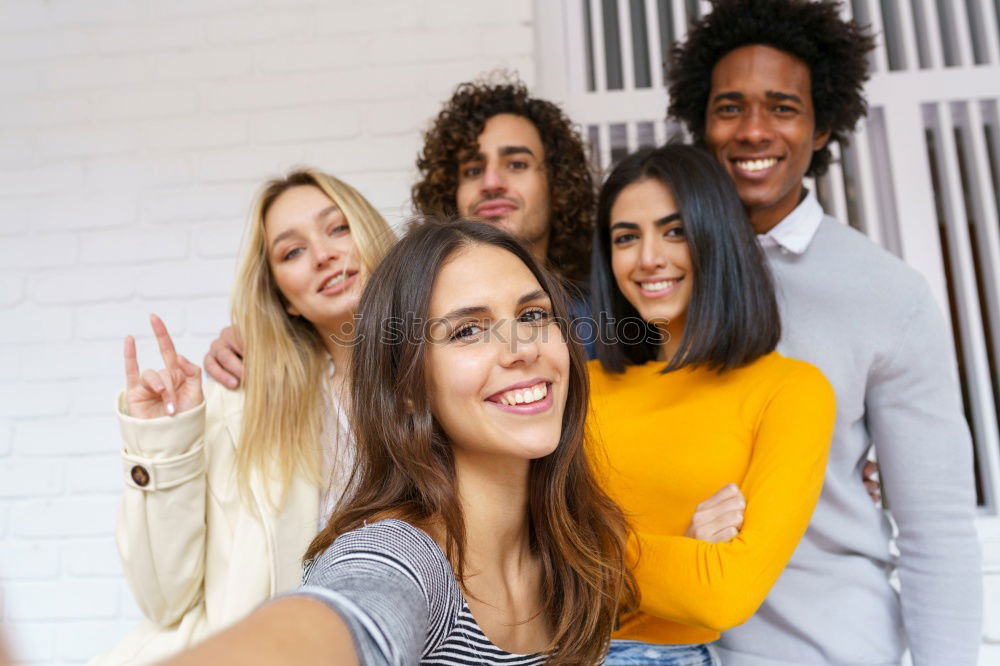 Similar – Multiracial group of friends taking selfie in a urban park