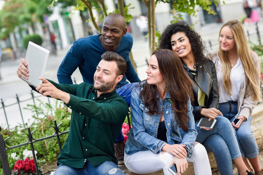 Similar – Multi-ethnic group of young people using smartphone