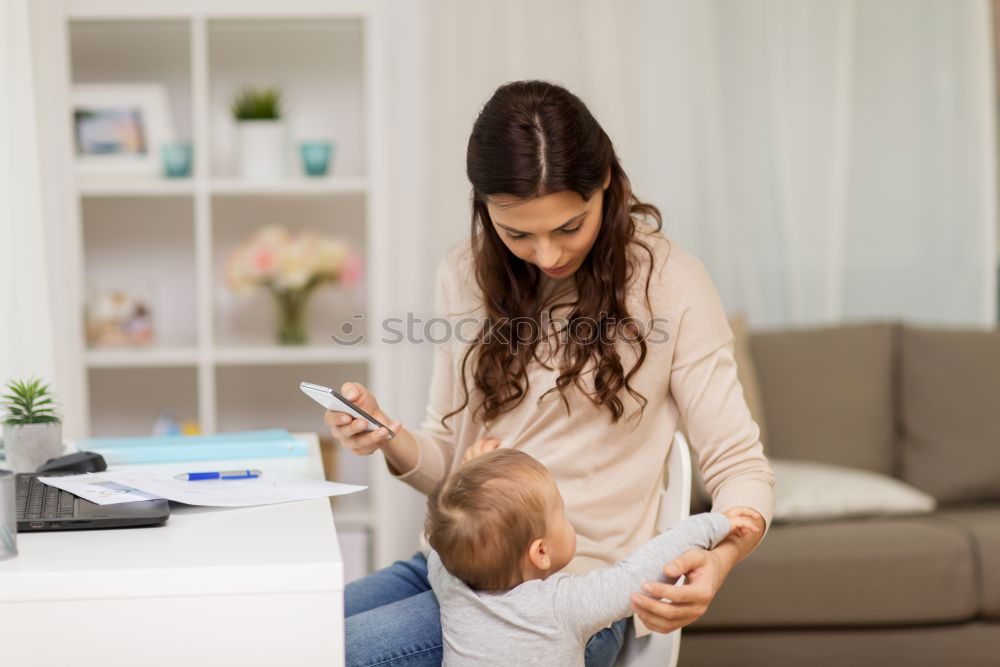 Similar – Mother breastfeed baby while playing with smartphone