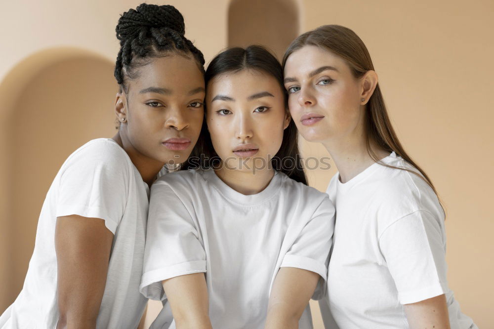 Cheerful multiracial women friends posing