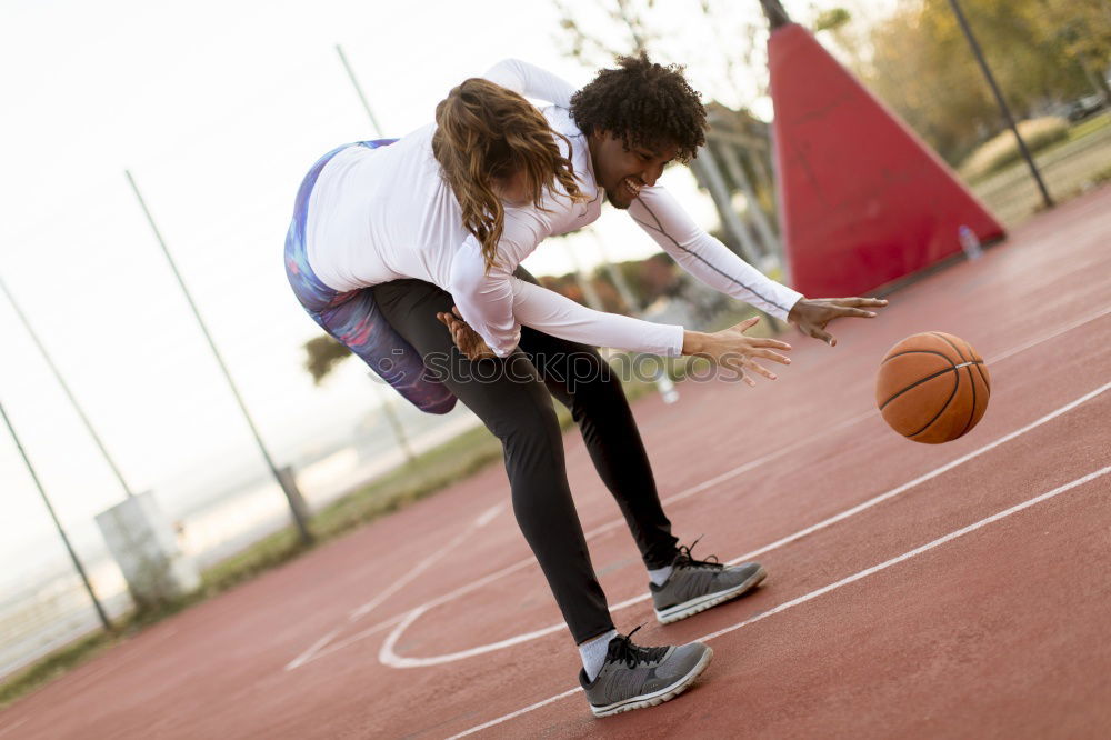 Similar – Image, Stock Photo Female basketball player stretching on sports ground