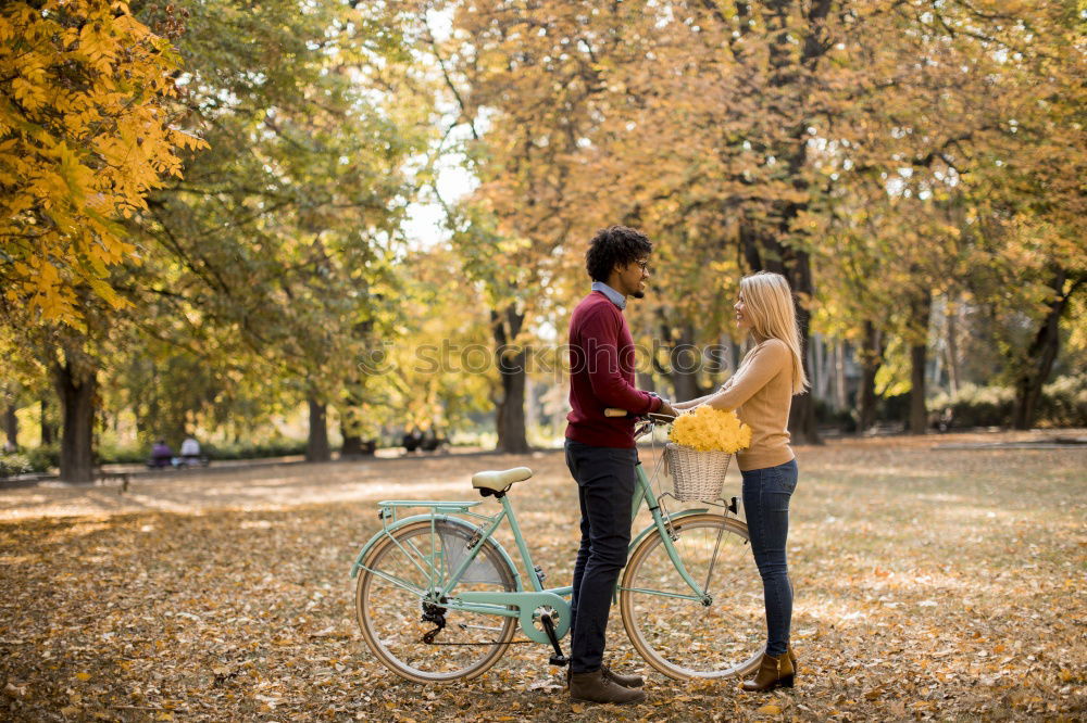 Similar – Couple makes a leaf fight in autumn