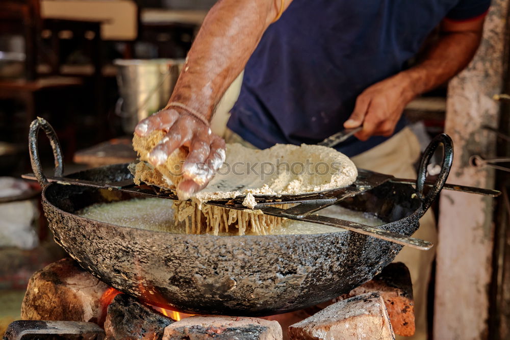 Similar – Blacksmith forges iron on anvil