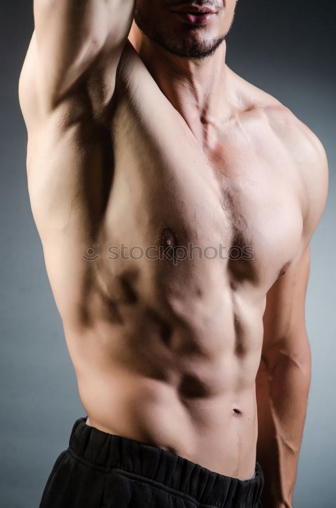 Similar – shirtless muscular man showing abs