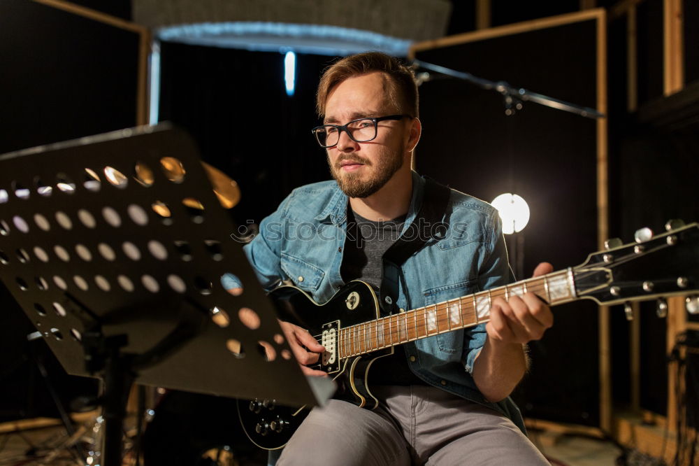 Image, Stock Photo Guitarist sitting on guitar combo