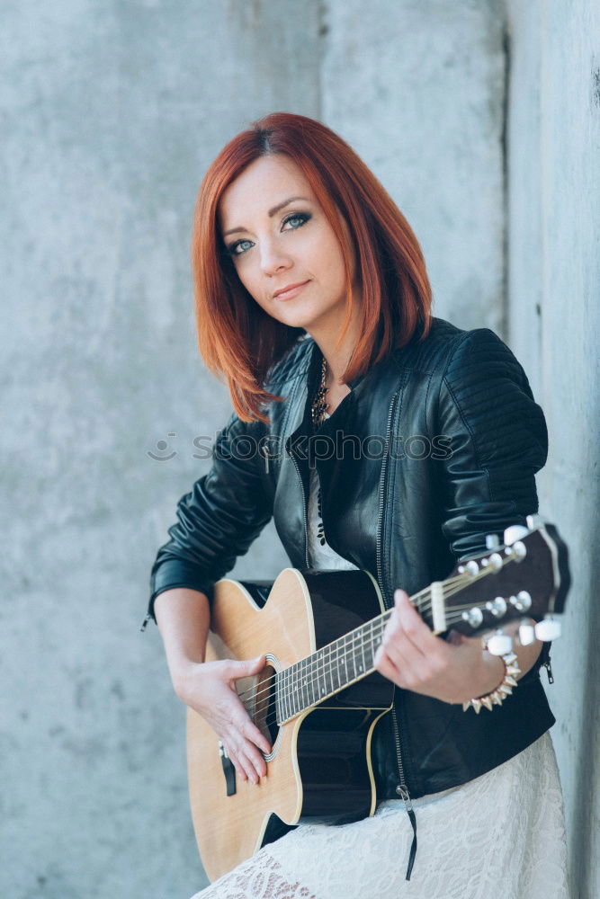 Similar – Pensive woman sitting near guitar on floor