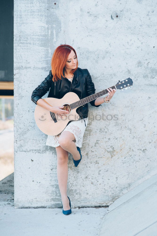 Similar – Pensive woman sitting near guitar on floor