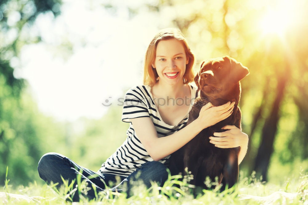 Happy smiling dog with its pretty young owner