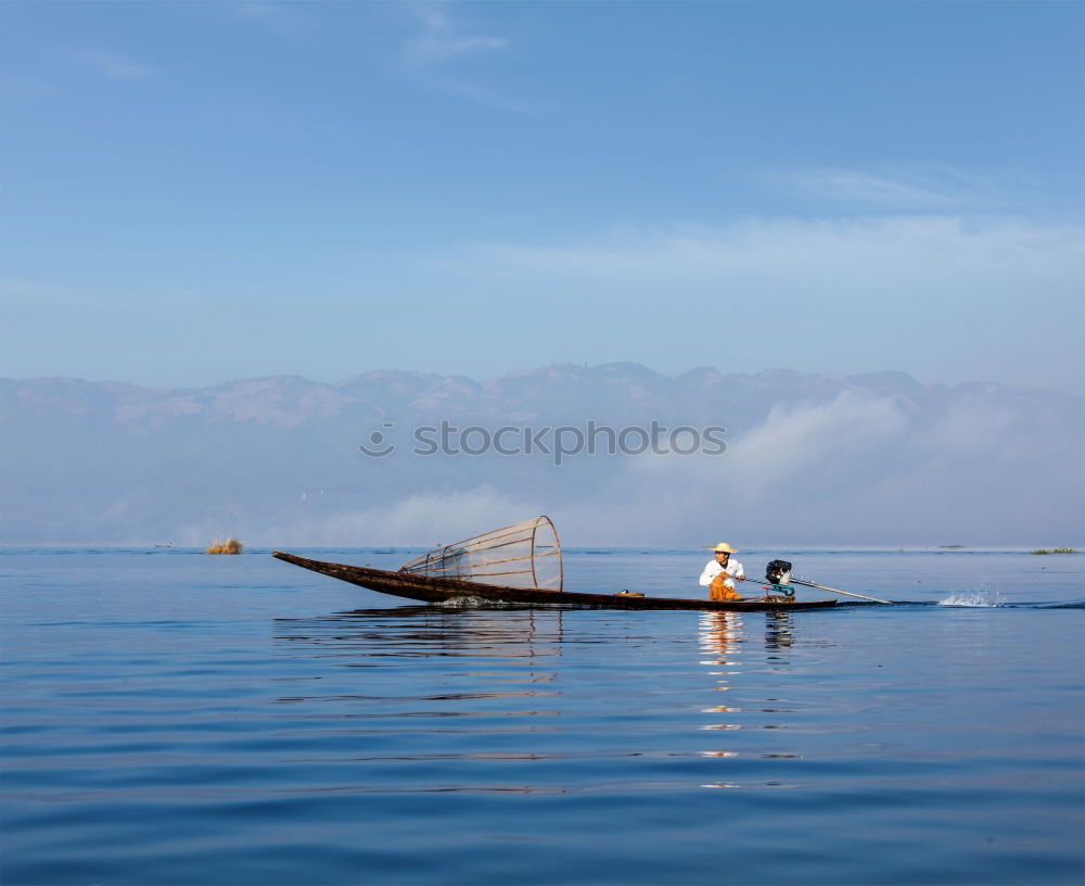 Fisher at bright Inle Lake