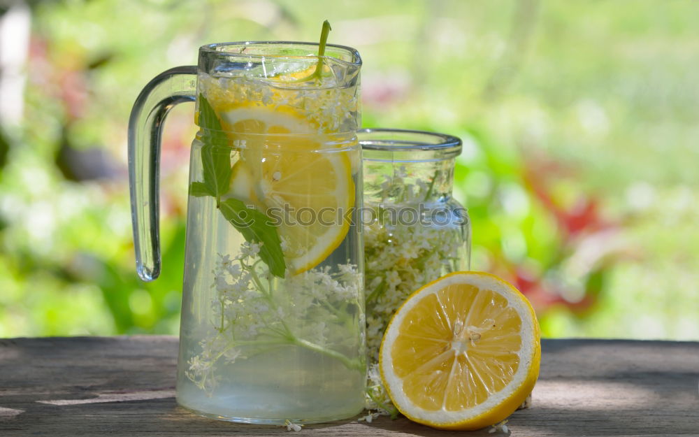 Elder lemonade with lemon on old table wood