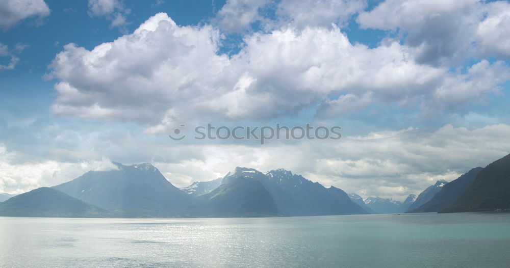 Similar – Coast of Norway sea in clouds of haze. Beacon on a rock