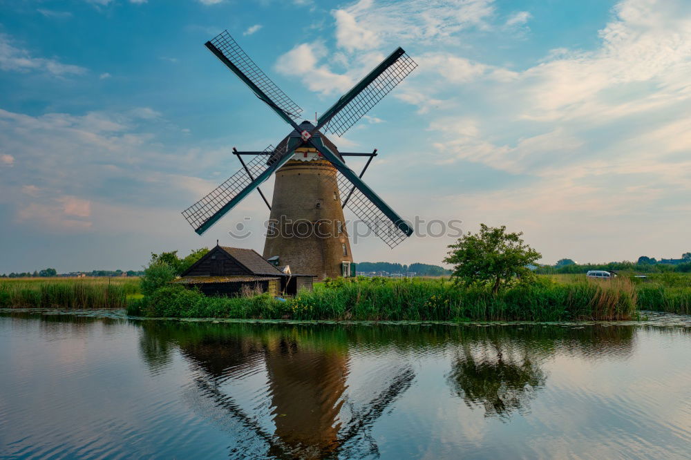 Similar – charming windmill by river at sunrise