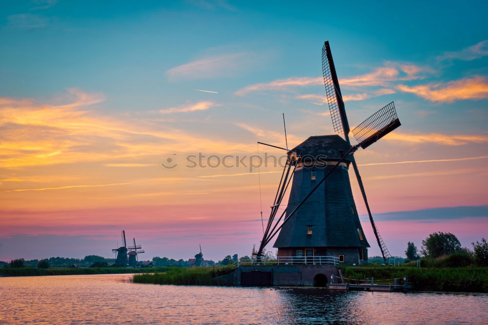 Similar – charming windmill by river at sunrise