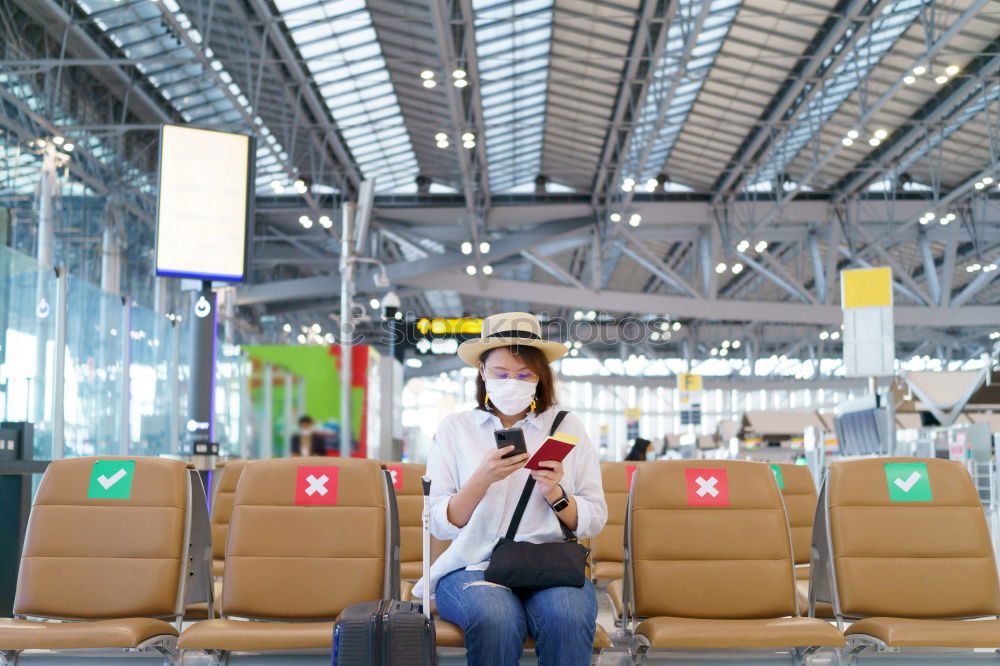 Image, Stock Photo Black Woman looking at the timetable information panel in the airport with a suitcase