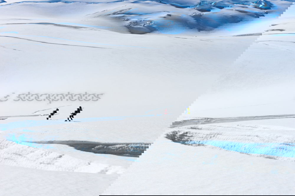 People walking on top of snowy mountains