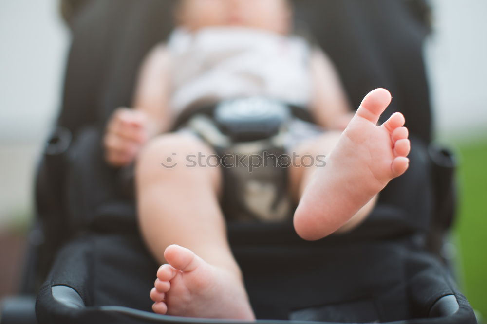 Little toddler in sitting stroller.