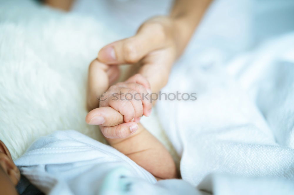 Similar – Baby girl sitting over legs of senior man outdoors