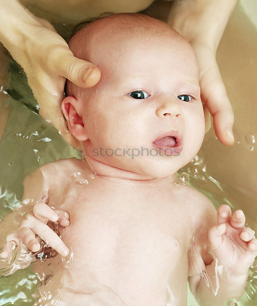 Similar – Bathing newborn baby girl.