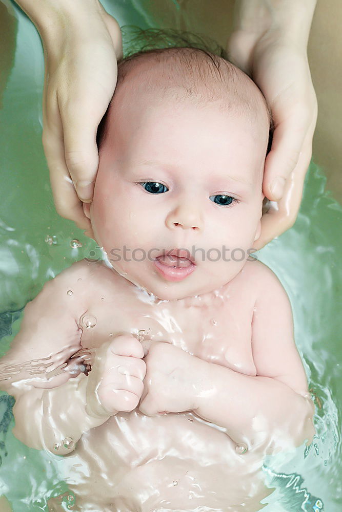 Similar – Bathing newborn baby girl.