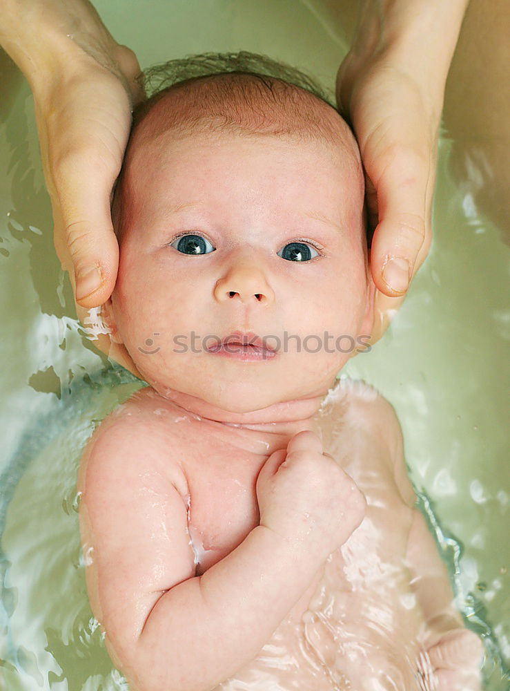 Similar – Bathing newborn baby girl.