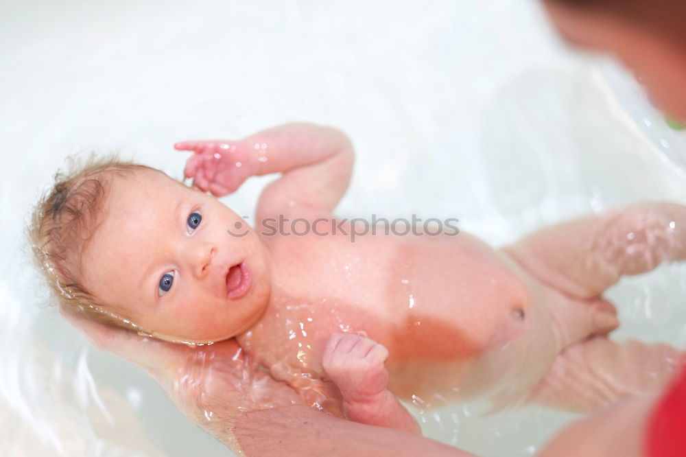 Similar – Bathing newborn baby girl.