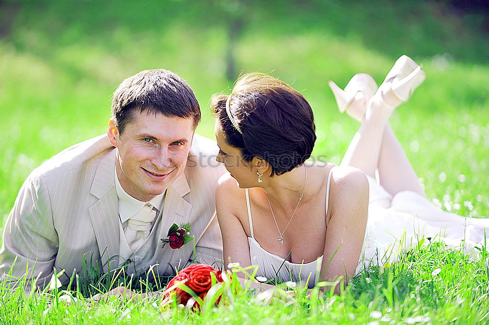 Similar – Happy smiling couple laying on green grass