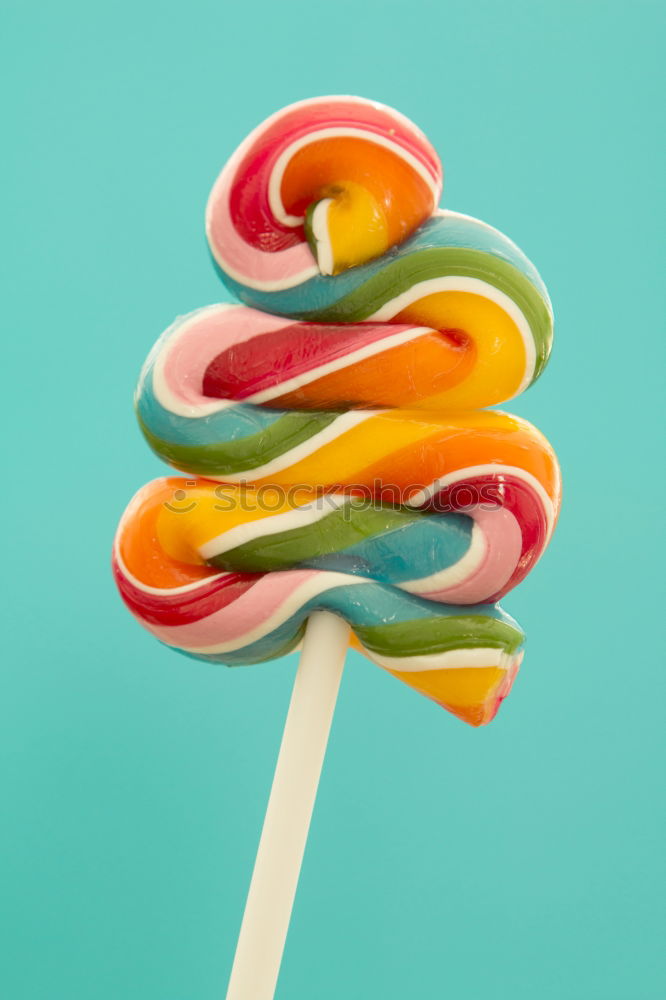 Similar – Image, Stock Photo Nice lollipop with many colors in a spiral on a blue background