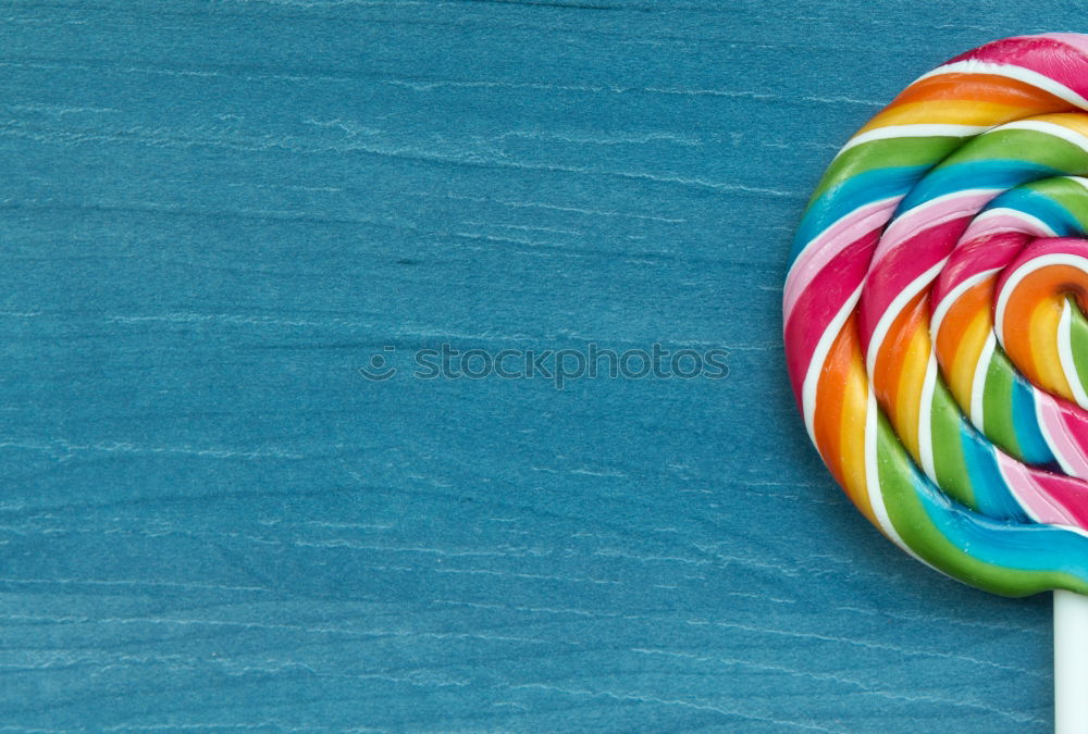 Similar – Colorful lollipop on blue background. Top view. Copyspace