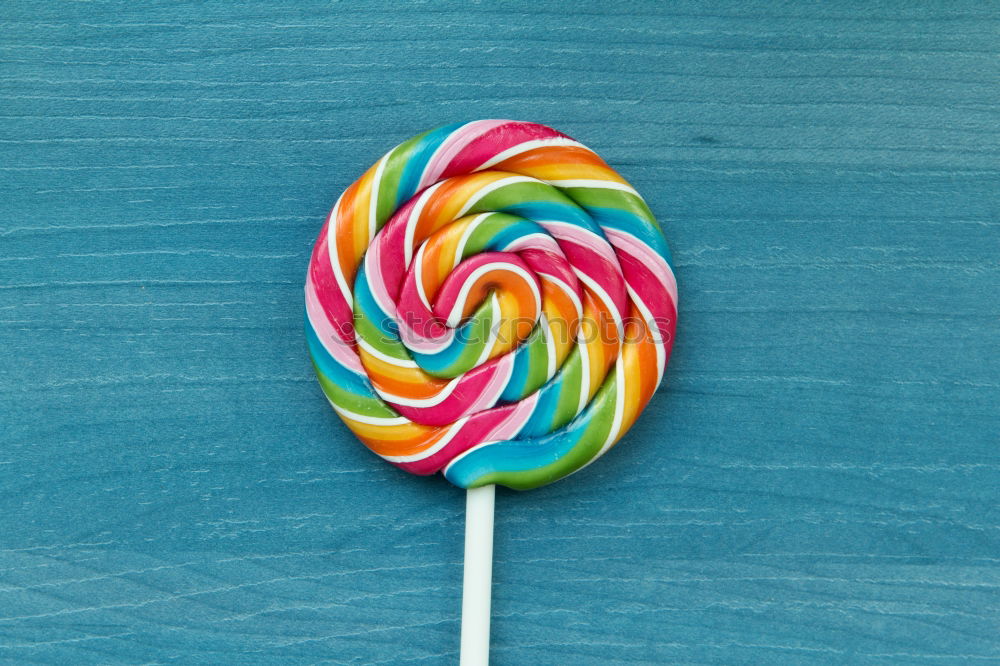 Similar – Colorful lollipop on blue background. Top view. Copyspace