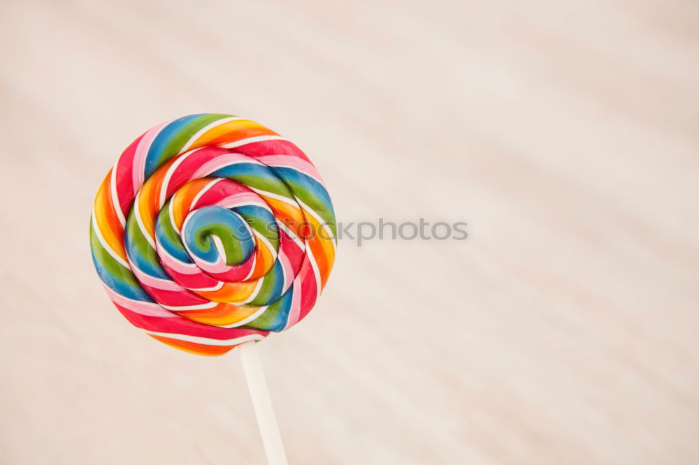 Similar – Woman hand holding three colorful lollipops