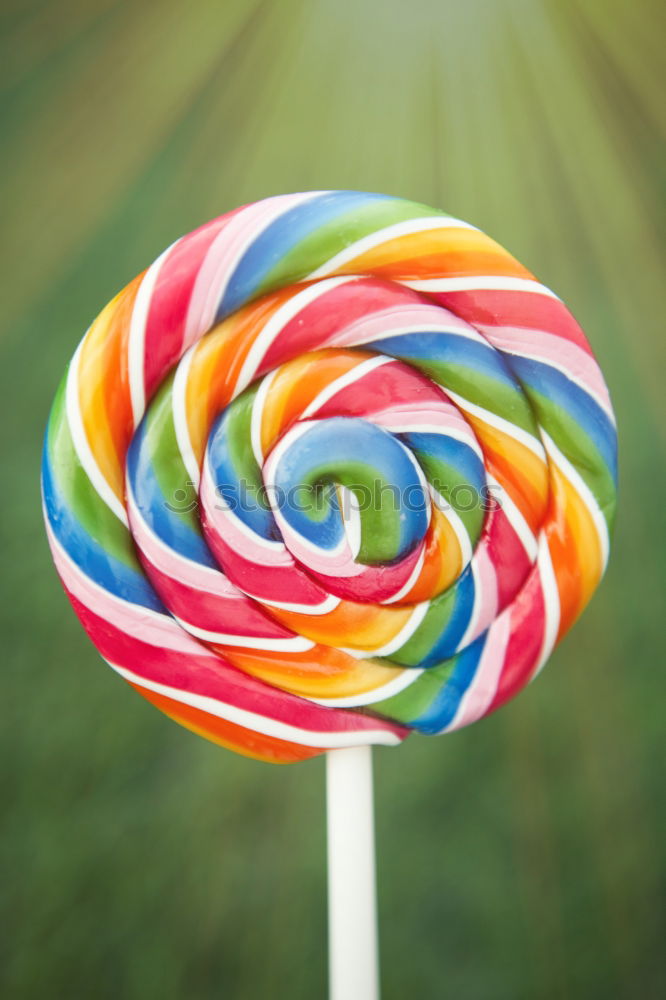 Similar – Image, Stock Photo Nice lollipop with many colors in a spiral on a blue background