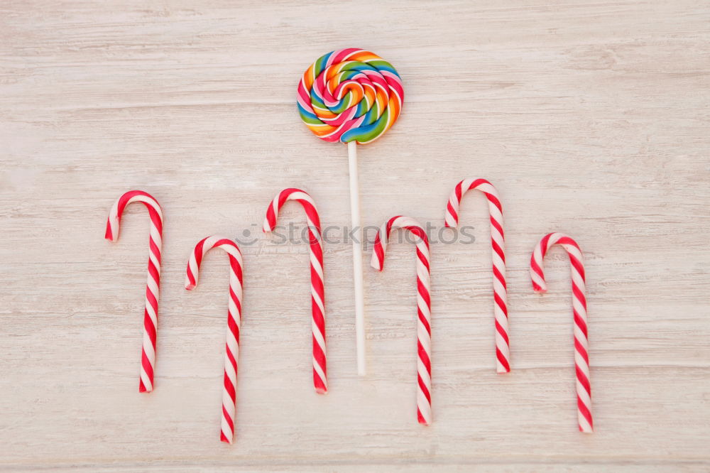 Similar – Woman hand holding three colorful lollipops