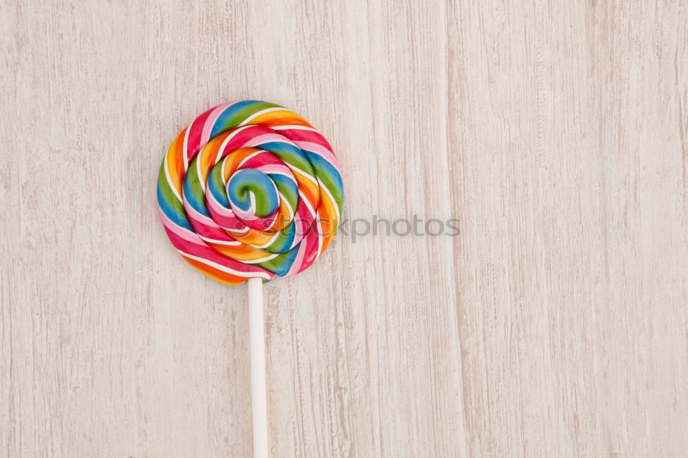 Similar – Woman hand holding three colorful lollipops