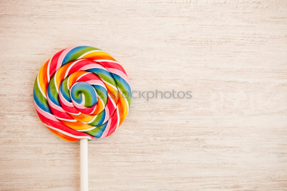 Similar – Woman hand holding three colorful lollipops