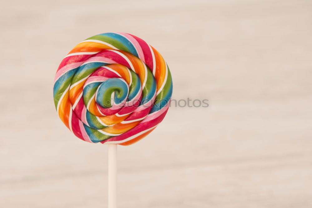 Similar – Woman hand holding three colorful lollipops