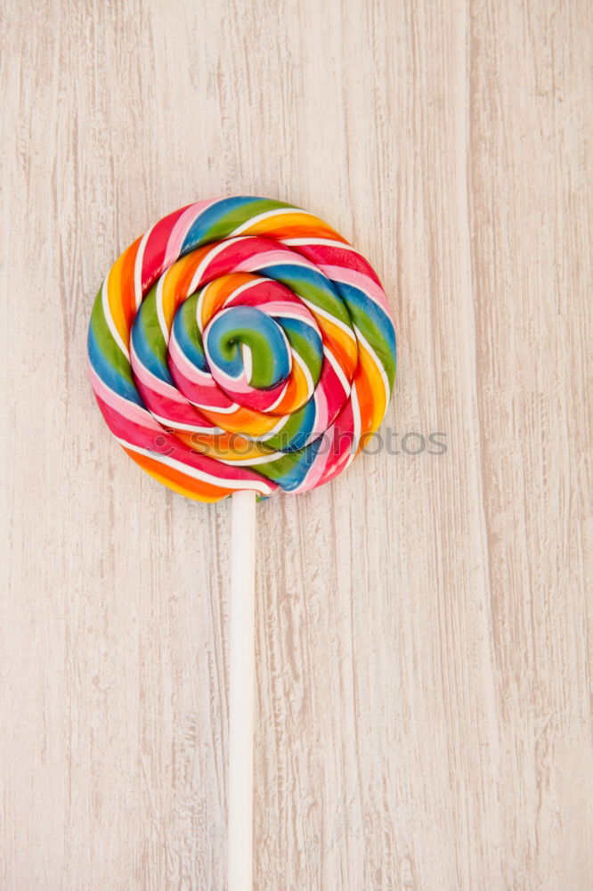 Similar – Woman hand holding three colorful lollipops