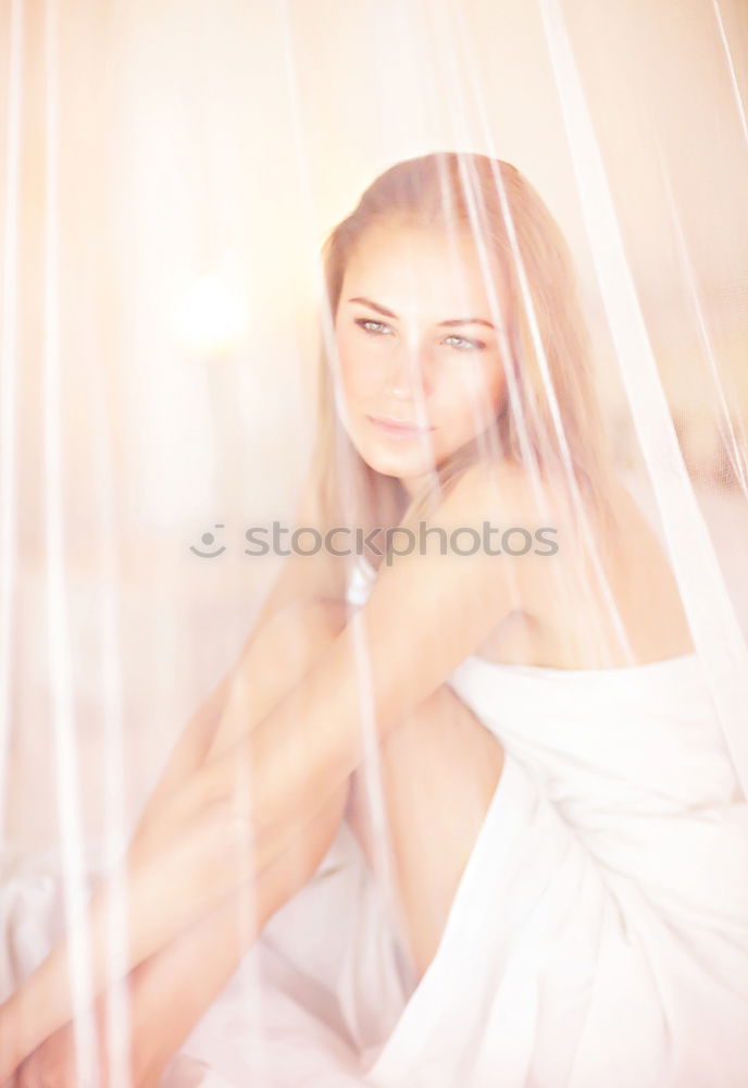 Similar – beautiful young woman with long flowing blond hair examines white wedding dress