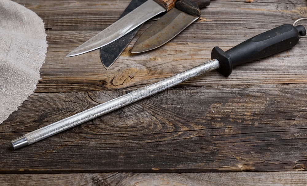 Similar – wooden cutting board and knife with sharpening on the table