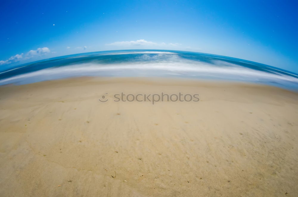 Similar – Image, Stock Photo Endless beach at Rainbow Beach. Walk left at the beach. A car is approaching. In the background a medium high mountain.