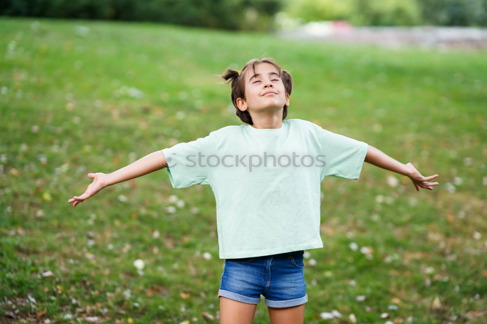 Similar – Image, Stock Photo Funny, funny, cheerful, happy, funny blonde girl outside in the garden, looks up and stretches both arms up to the tree. Little joker does nonsense, sticks out her tongue, in nature, in the park under the tree.