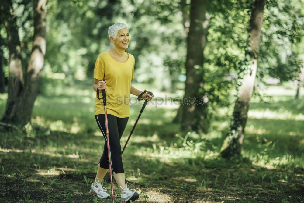 Happy senior couple on a hike trough green fields