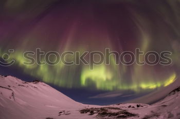 Similar – Northern lights before mountain silhouette