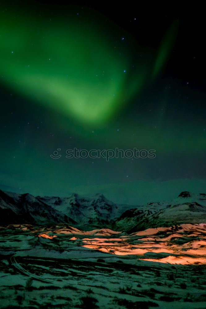 Similar – Northern lights before mountain silhouette